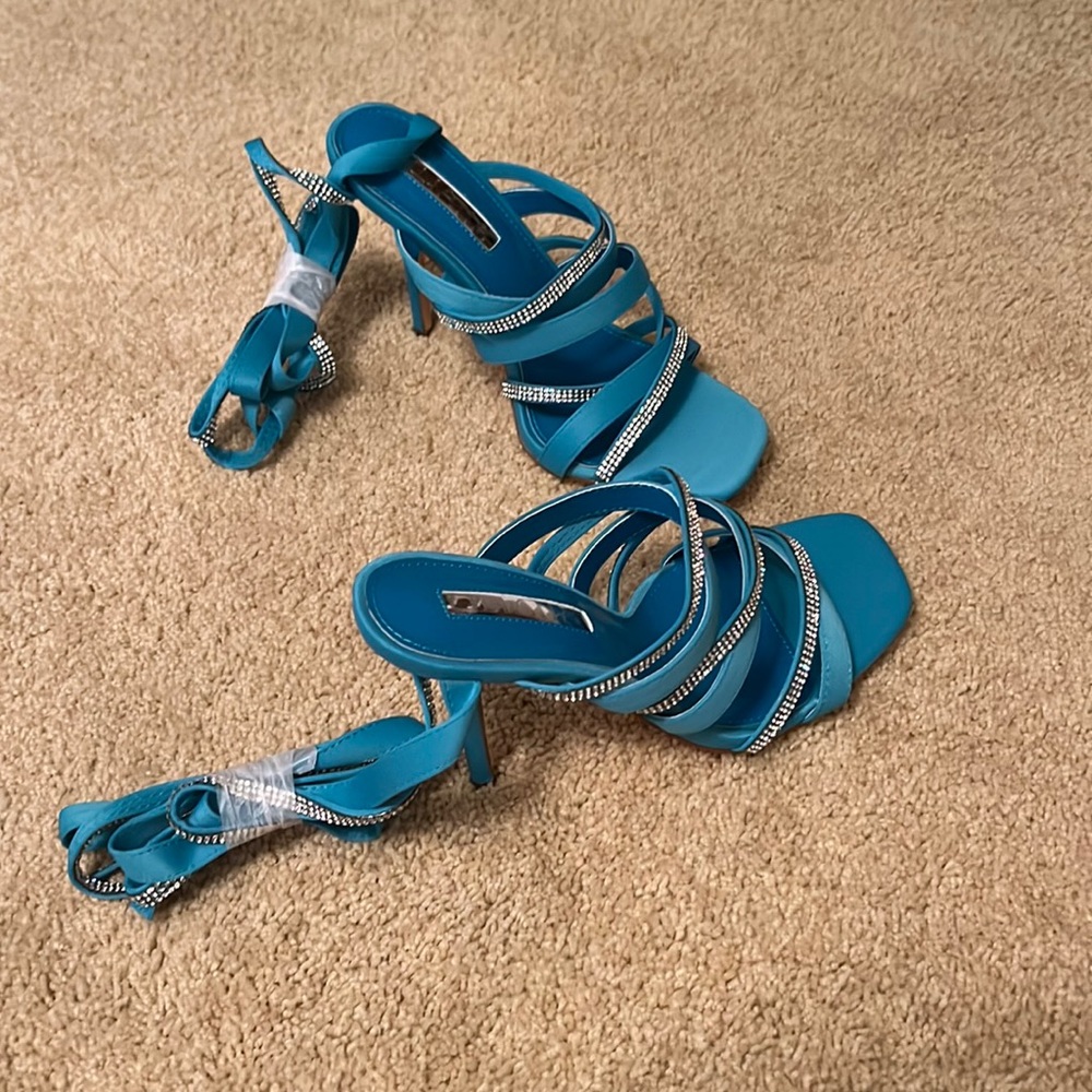 New, never worn Teal colored heels with ankle wrap